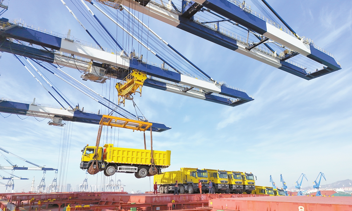 Engineering vehicles exported to Guinea are loaded onto the China-Africa liner at Yantai Port, East China's Shandong Province, on January 25, 2024. Photo: VCG